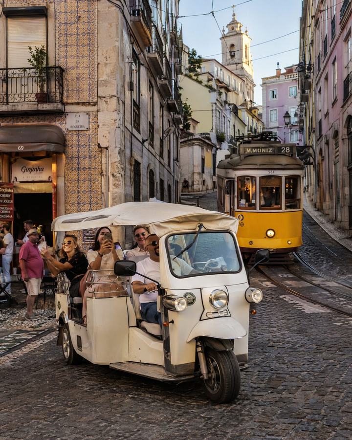 Tuk tuk with guests in a historic Lisbon street